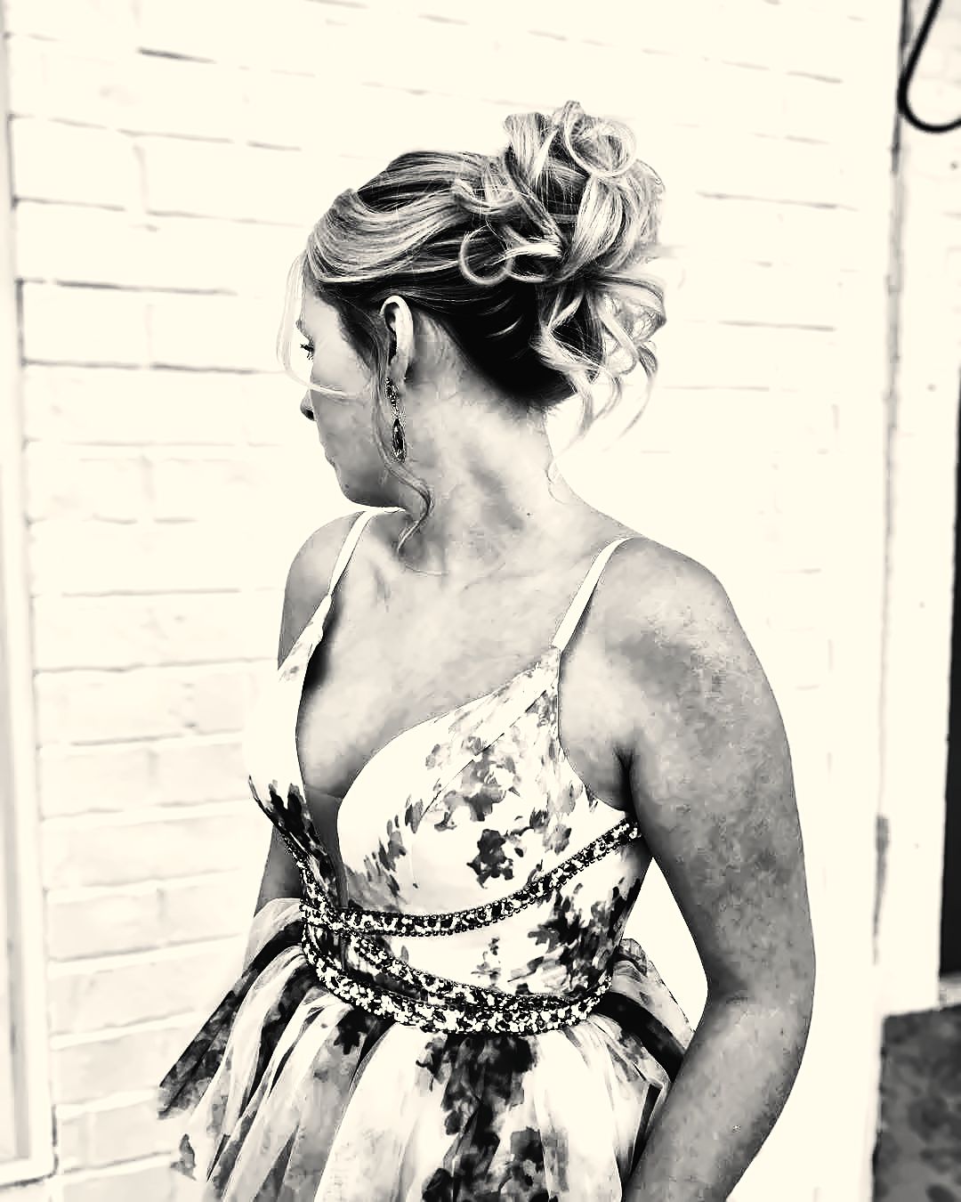 Textured event updo with face-framing tendrils